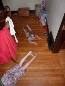 Bethany and Claire doing "swimming lessons" in the dining room.